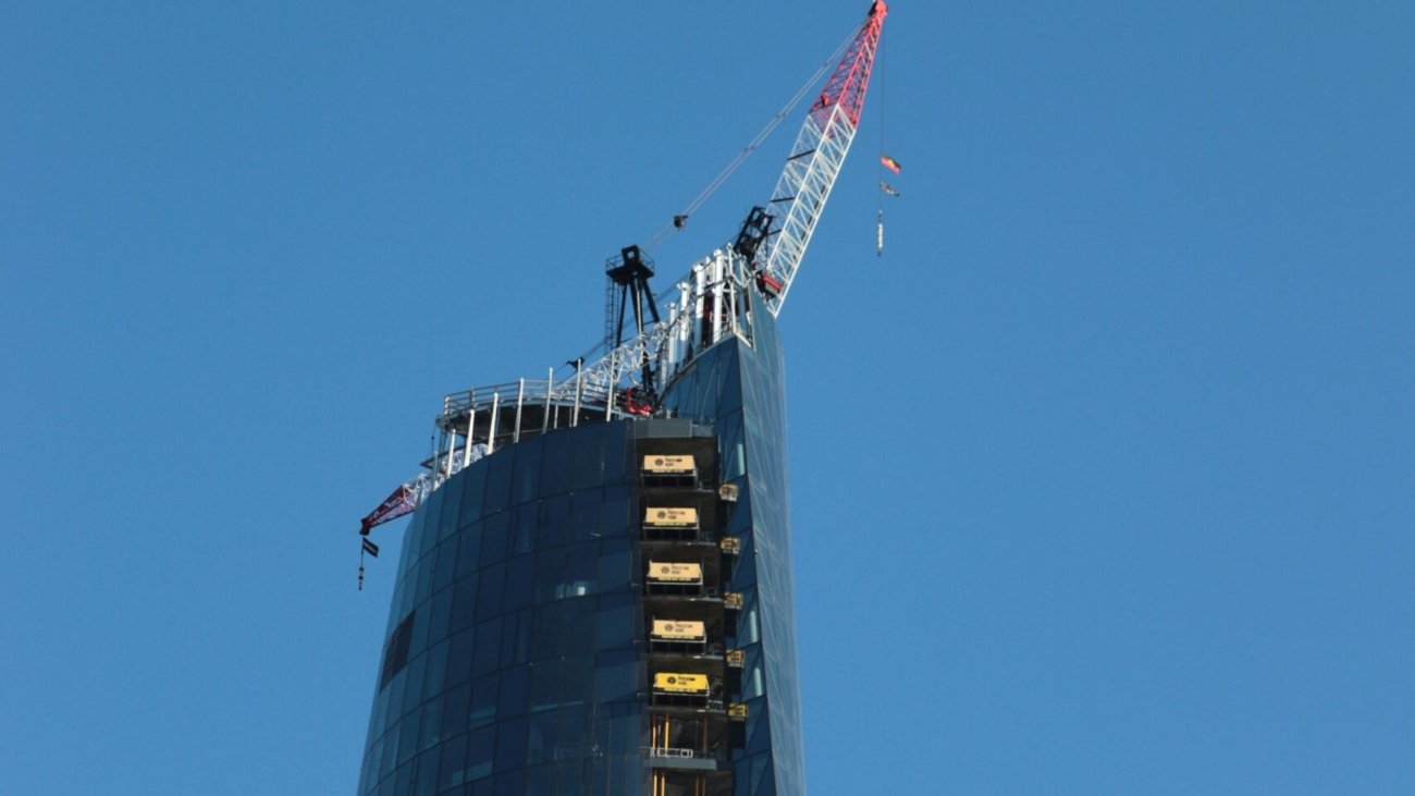a very tall building with a crane on top of it